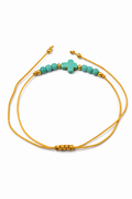 Pulsera ajustable con cruz turquesa y detalles dorados