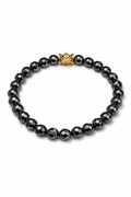 Pulsera de cuentas facetadas con corona dorada